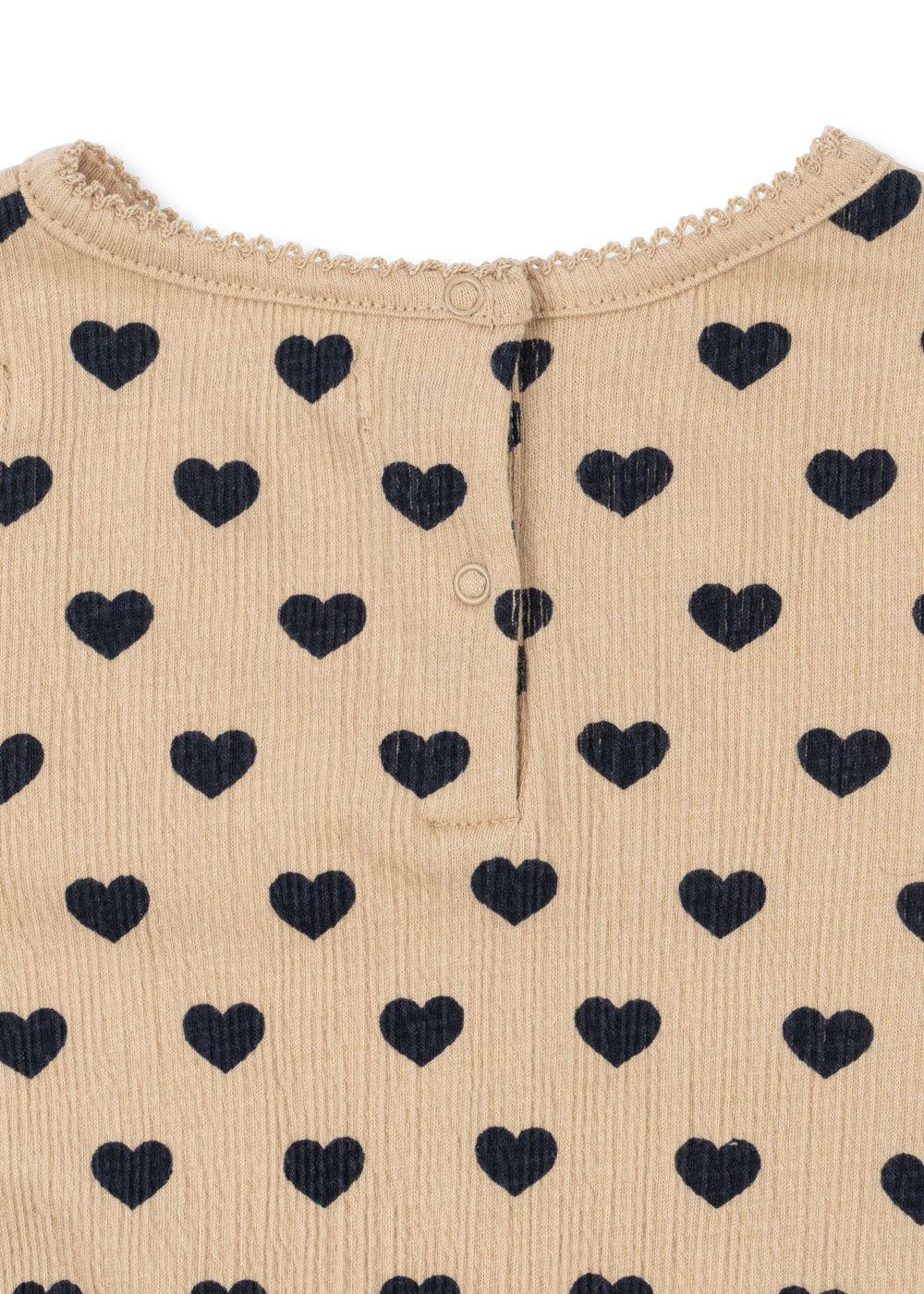 Close-up of Konges Sløjd Chleo romper in Coeur eclipse fabric
