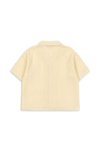 Back view of a Konges Sløjd Coco shirt on a white background