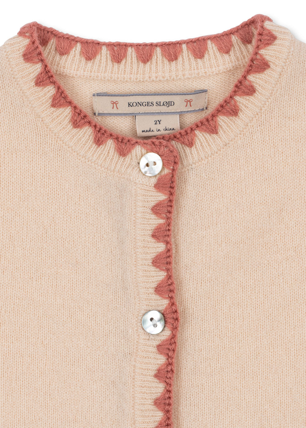Close-up of the Konges Sløjd Collette Cardigan in Rosey on a white background.