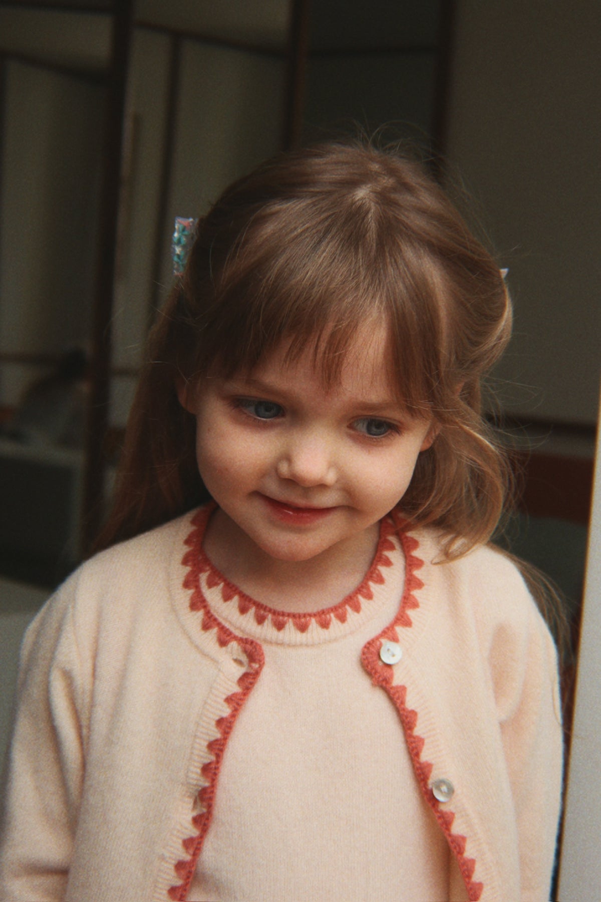 Young girl wearing the Konges Sløjd Collette Dress and Collette Cardigan in Rosey.