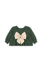 Back view of the Konges Sløjd Elin bow blouse in Dot Marseille on a white background.
