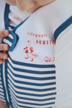 Close-up of a child wearing the Konges Sløjd Ellis swim vest in Marin stripe