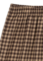 Close-up of the Konges Sløjd Foret Pants in Chocolate Check on a white background.