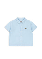 Front view of a Konges Sløjd Fran shirt in blue check on a white background