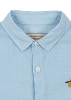 Close-up of the Konges Sløjd Fran shirt in blue check on a white background
