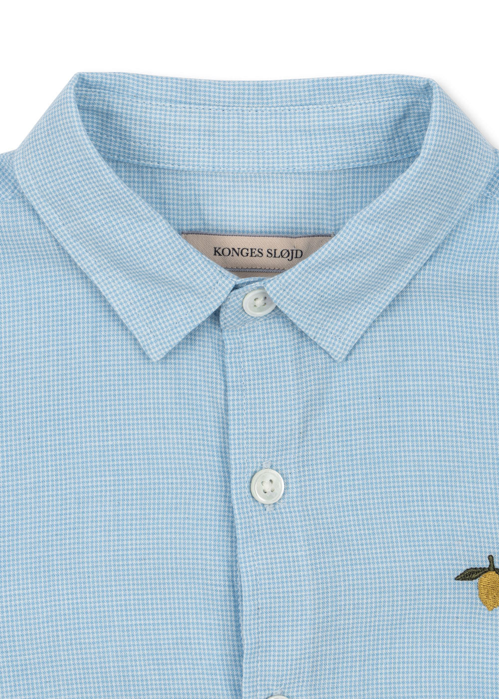 Close-up of the Konges Sløjd Fran shirt in blue check on a white background