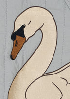 Close-up of the embroidered swan design of the Konges Sløjd Juno Bomber Jacket in Sleet.