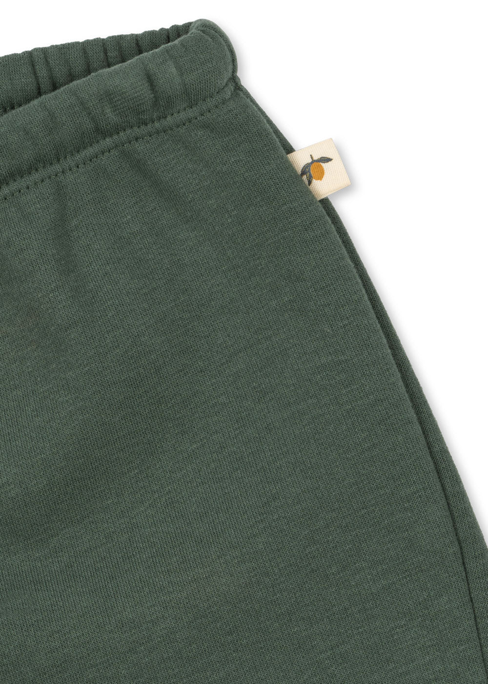 Close-up of a Konges Sløjd Lou sweat shorts in cilantro on a white background
