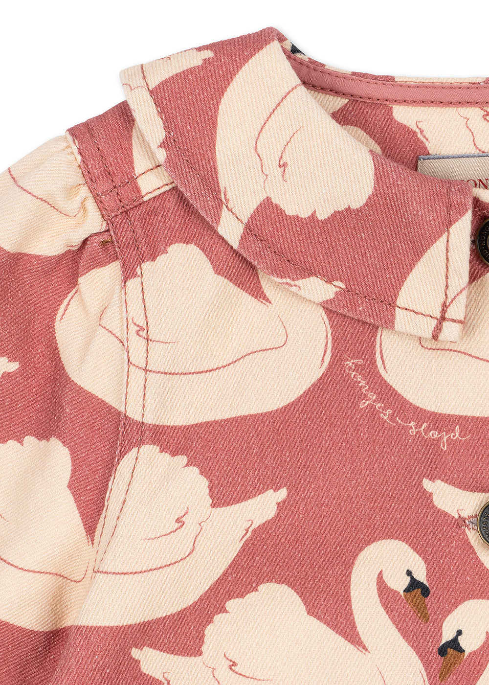 Close-up of the Konges Sløjd Magot Frill Jacket in Swan Rose on a white background.