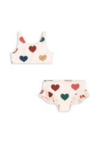 Front view of the Konges Sløjd Manuca bikinis in Bon coeur coloré on a white background