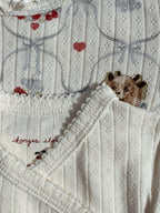 Close-up of Konges Sløjd Minnie body in Antique white collar and fabric