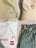Konges Sløjd Pomio bucket hat in banana crepe styled with other swim accessoires