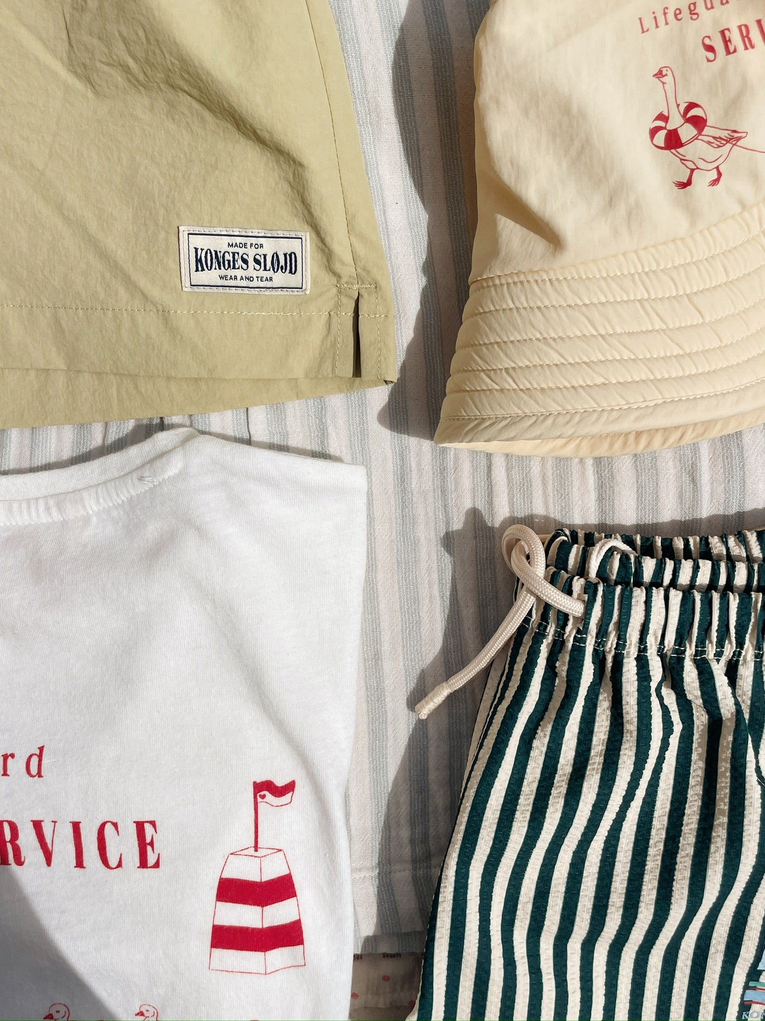 Konges Sløjd Pomio bucket hat in banana crepe styled with other swim accessoires