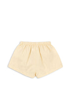 Back view of the Konges Sløjd Pomio short swim shorts in banana crepe on a white background