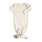 Mushie ribbed knotted baby gown in Ivory on a white background