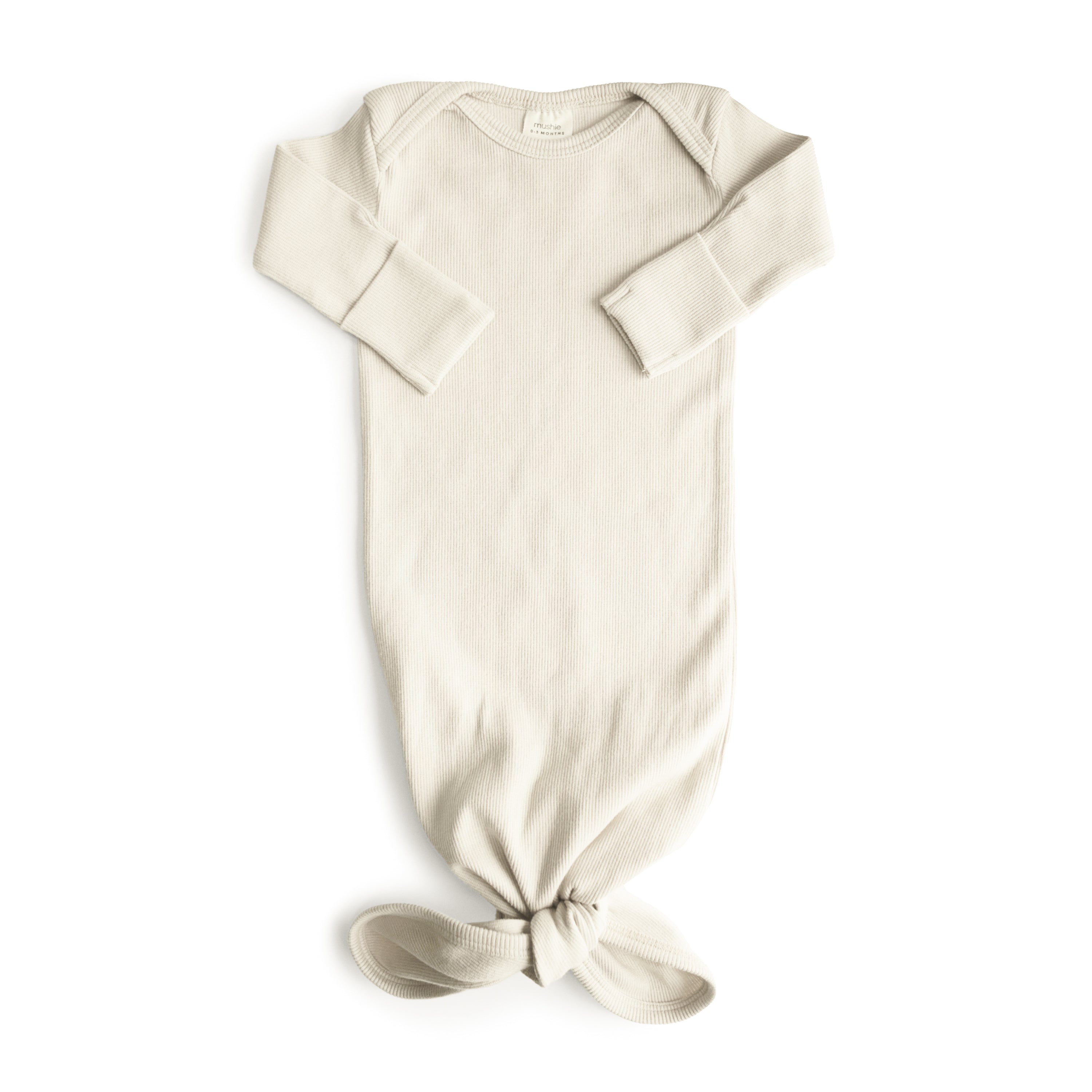 Mushie ribbed knotted baby gown in Ivory on a white background