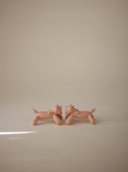 Two Mushie figurine teethers in Unicorn on a beige background