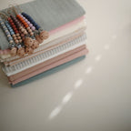 A product from the Mushie and FRIGG Giftbox Girl on a neutral background