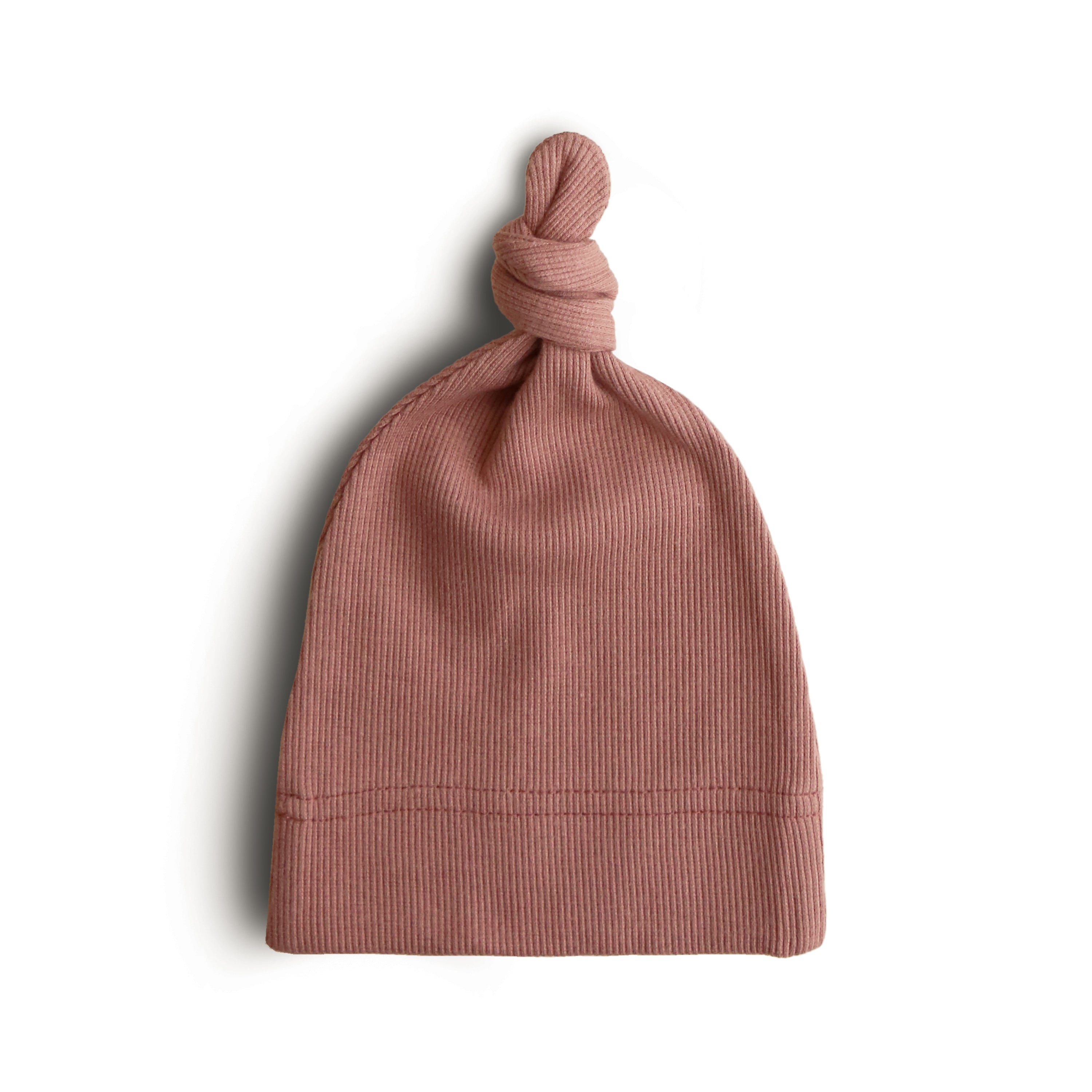 Mushie ribbed baby beanie in Cedar on a white background