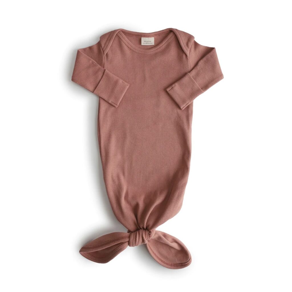 Mushie ribbed knotted baby gown in Cedar on a white background