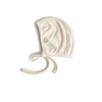 Mushie ribbed baby bonnet in Ivory on a white background