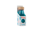 Petit Boum Turquoise sensory bottle lifestyle image showing a unicorn figurine, a rainbow charm and rainbow-shaped candies arranged nearby