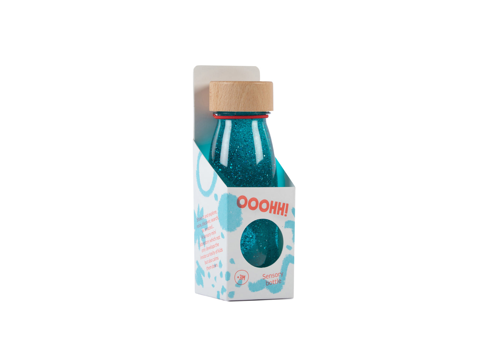 Petit Boum Turquoise sensory bottle lifestyle image showing a unicorn figurine, a rainbow charm and rainbow-shaped candies arranged nearby