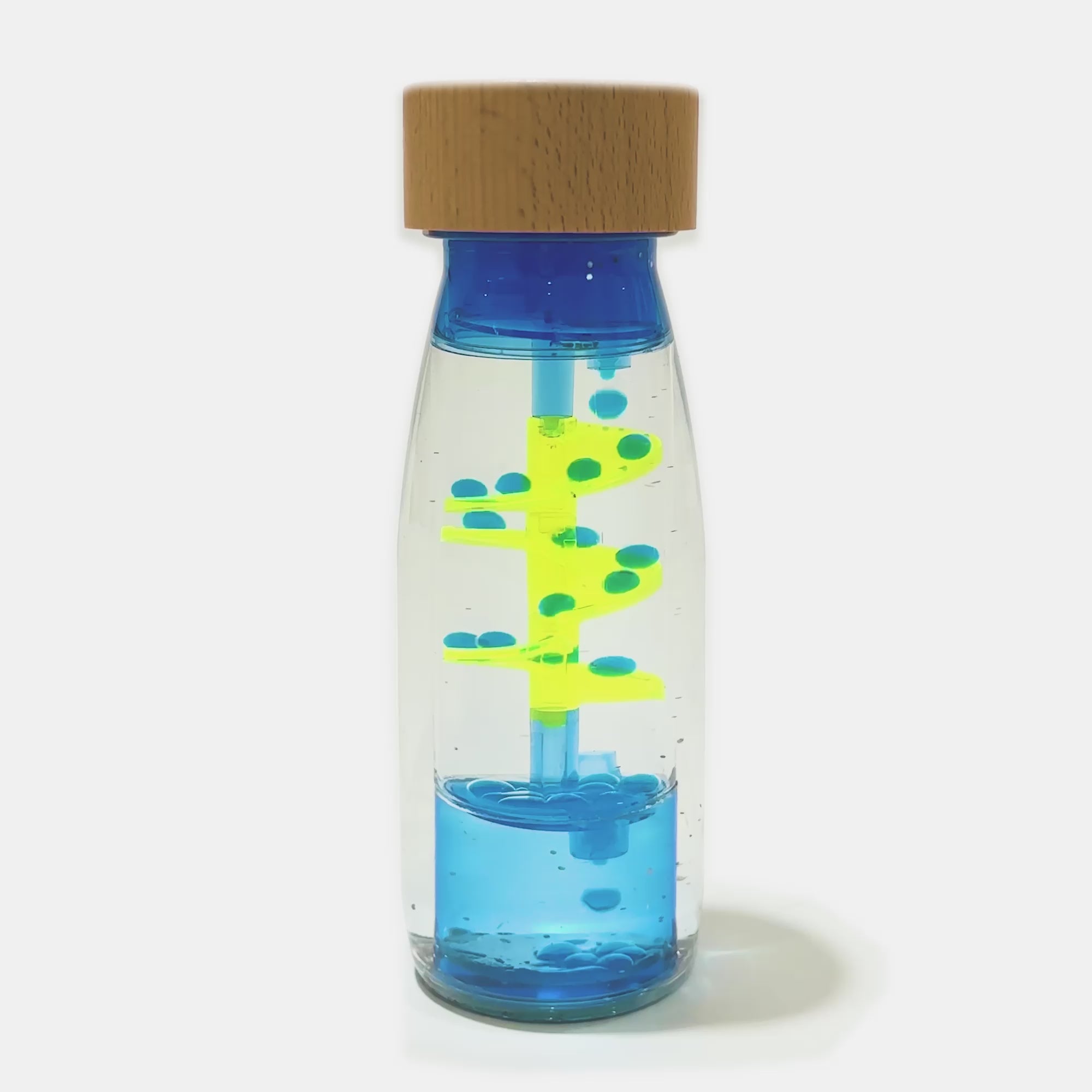 Demo video of Petit Boum Spiral blue sensory bottle showing swirling blue liquid and sensory yellow spiral motion