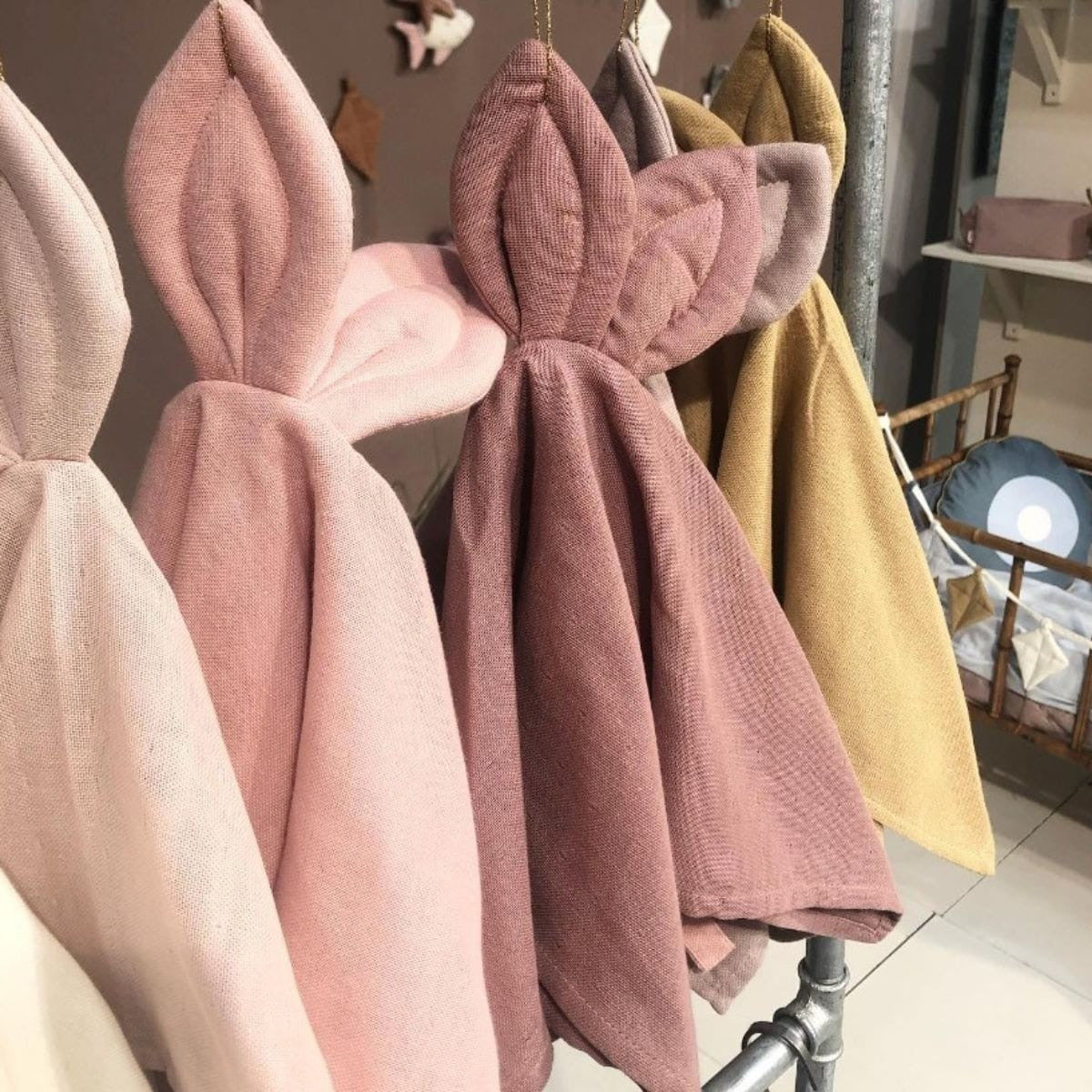 Sage Copenhagen Snoppa cuddle cloth in Burlwood hanging beside cuddle cloths in different colors